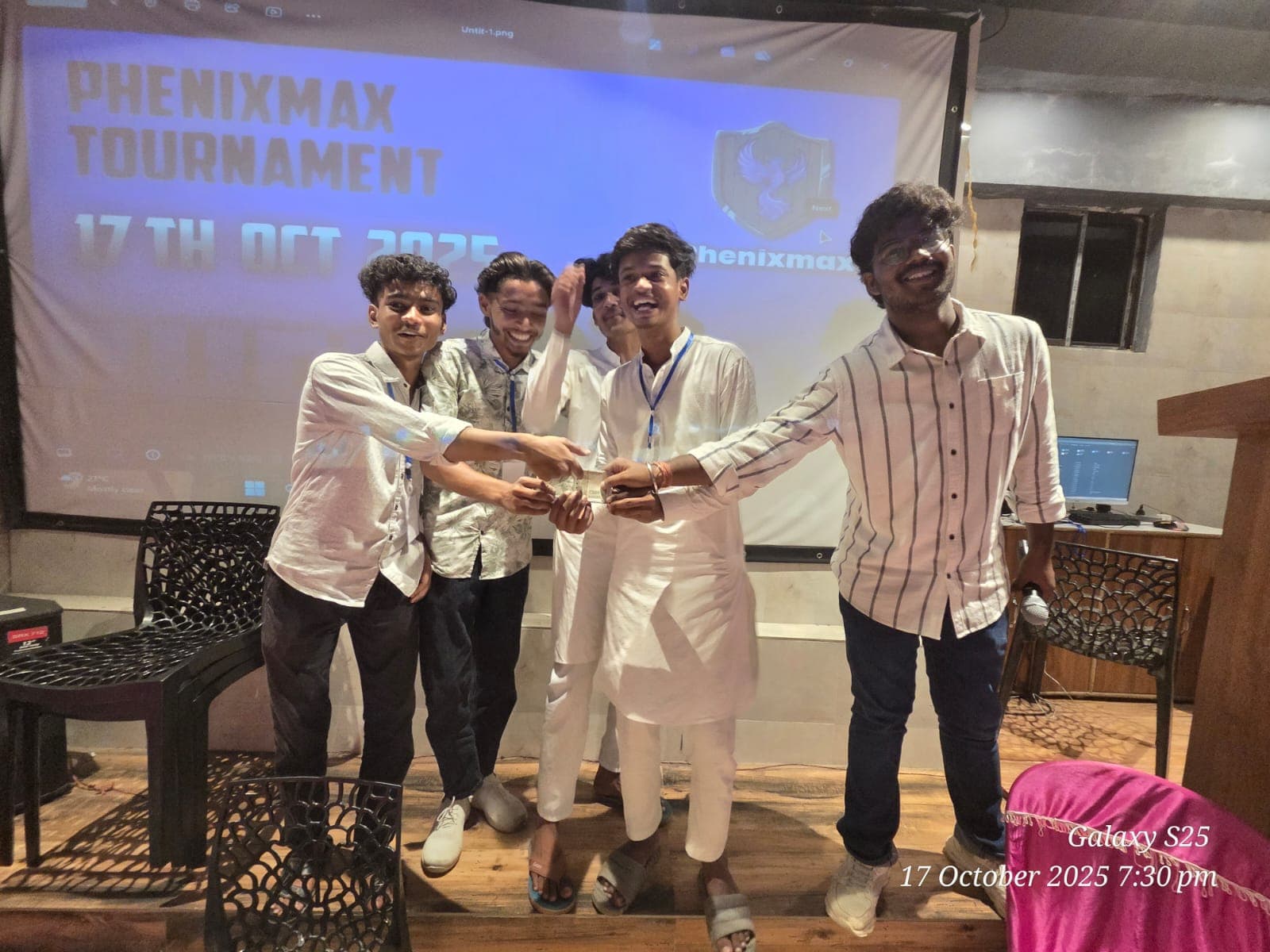 Six people present an award at a PHENIXMAX tournament.
